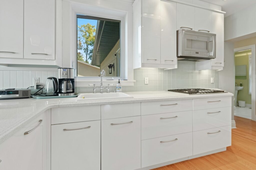 a kitchen with white cabinets and a stove top oven